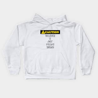 Caution: This vehicle is just passing through (black letters). Kids Hoodie